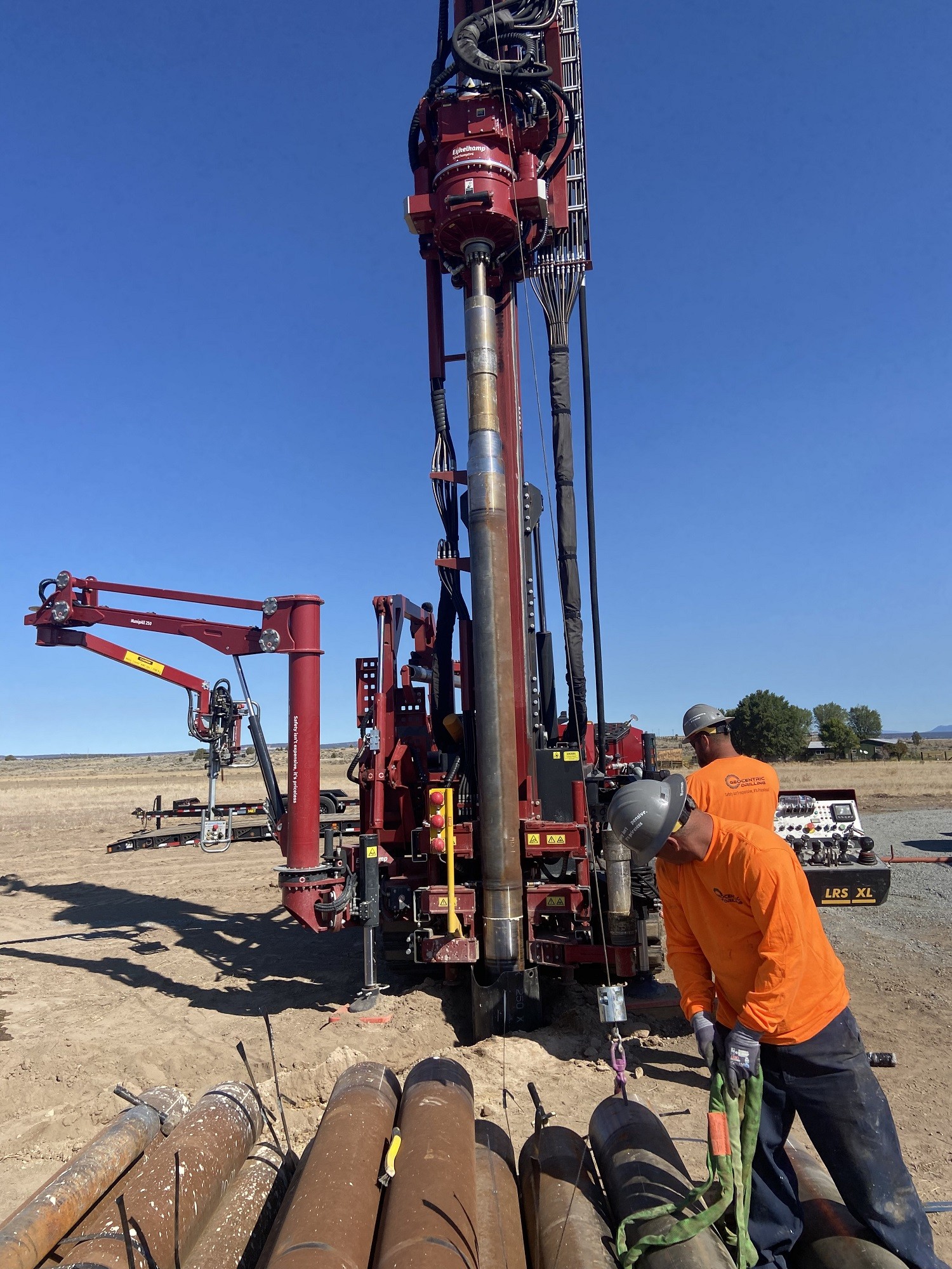 workers operating sonic drill on water supply well